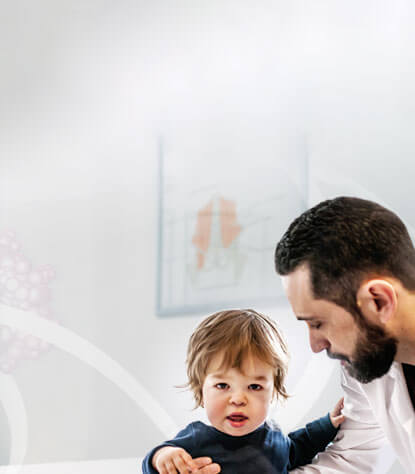 Photo of child & physician: we are working to make a difference for physicians treating patients with rare endocrine diseases & cancer
